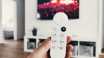person holding white remote control