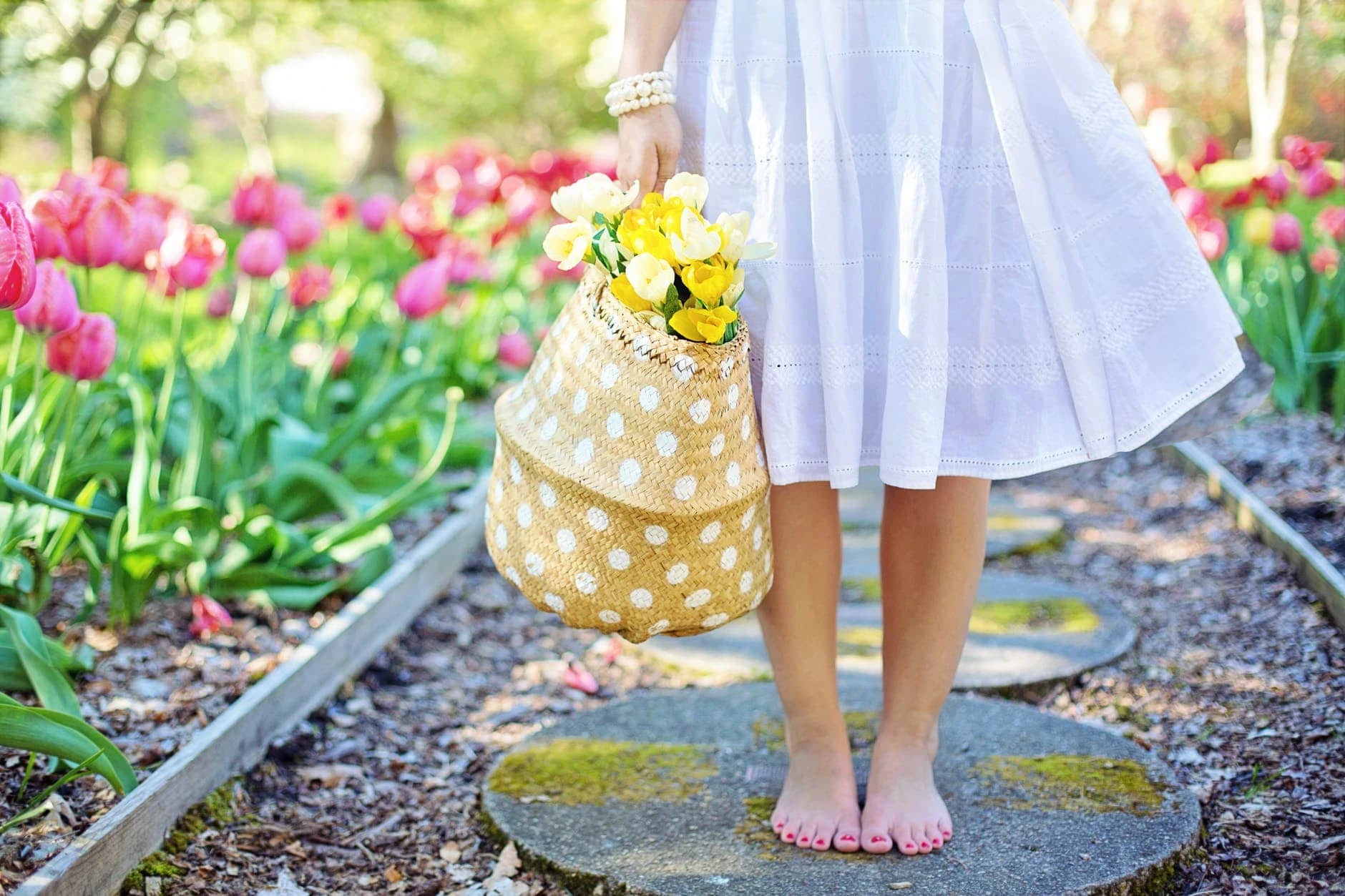 woman holding brown basket with yellow flowers