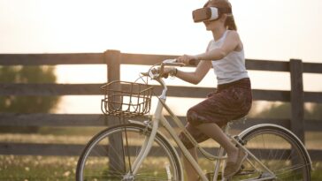 Girl Wearing Vr Box Driving Bicycle during Golden Hour