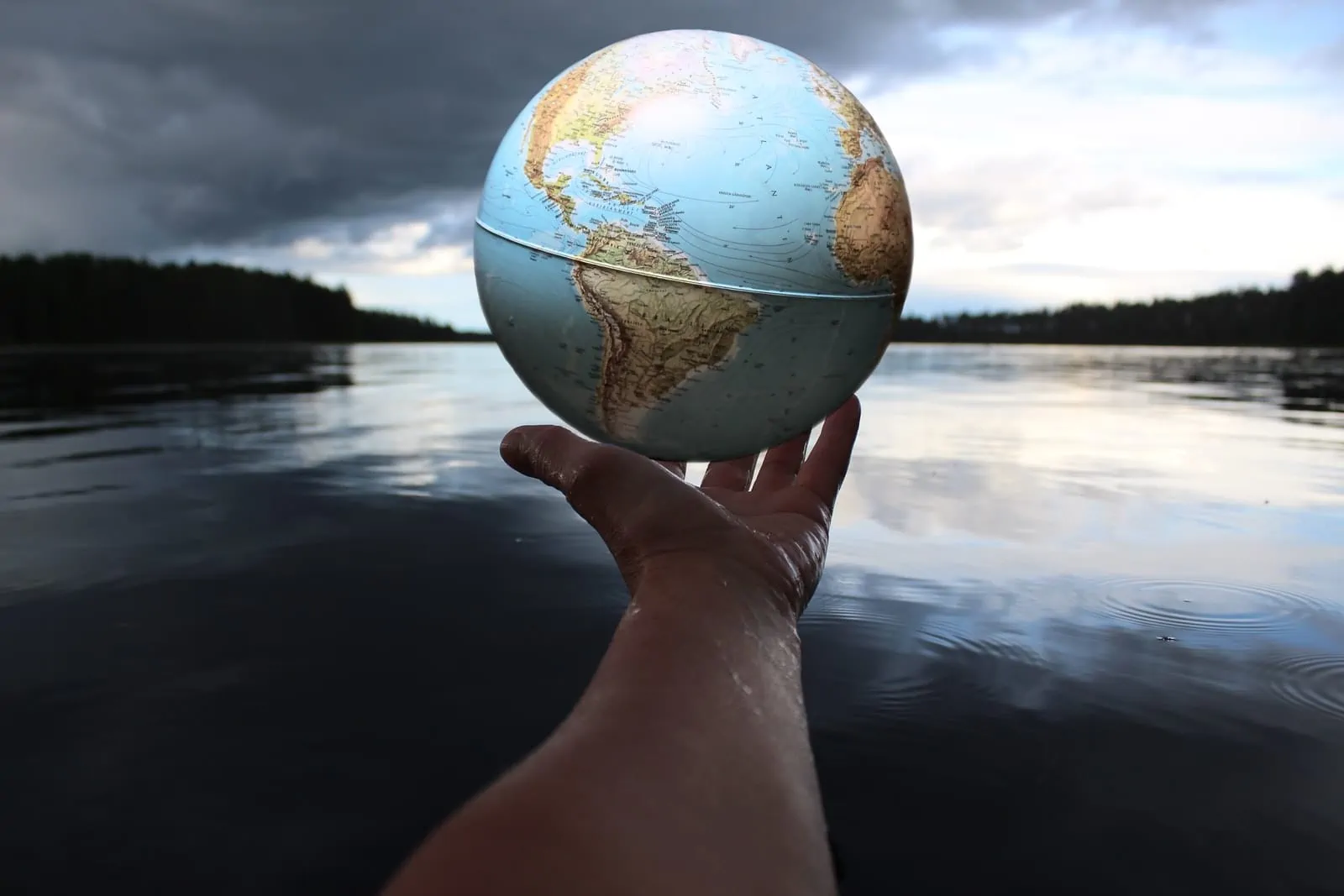 person holding clear glass ball