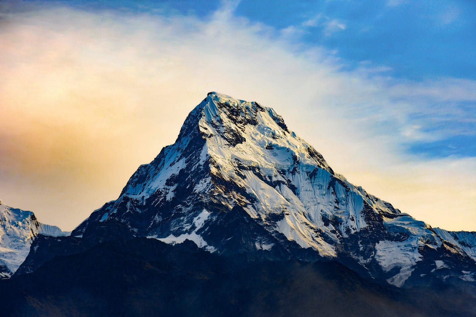 snow covered mountain under cloudy sky during daytime