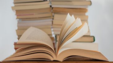 white book on brown wooden table