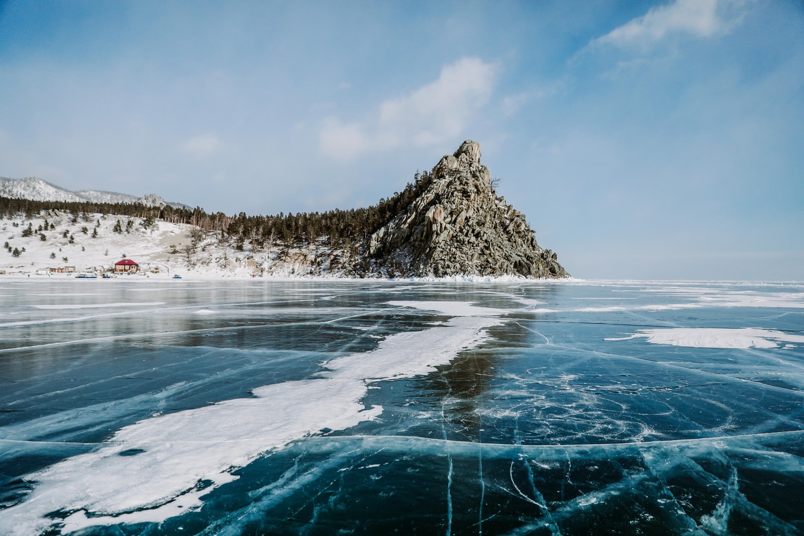 brown and white rock formation on body of water during daytime